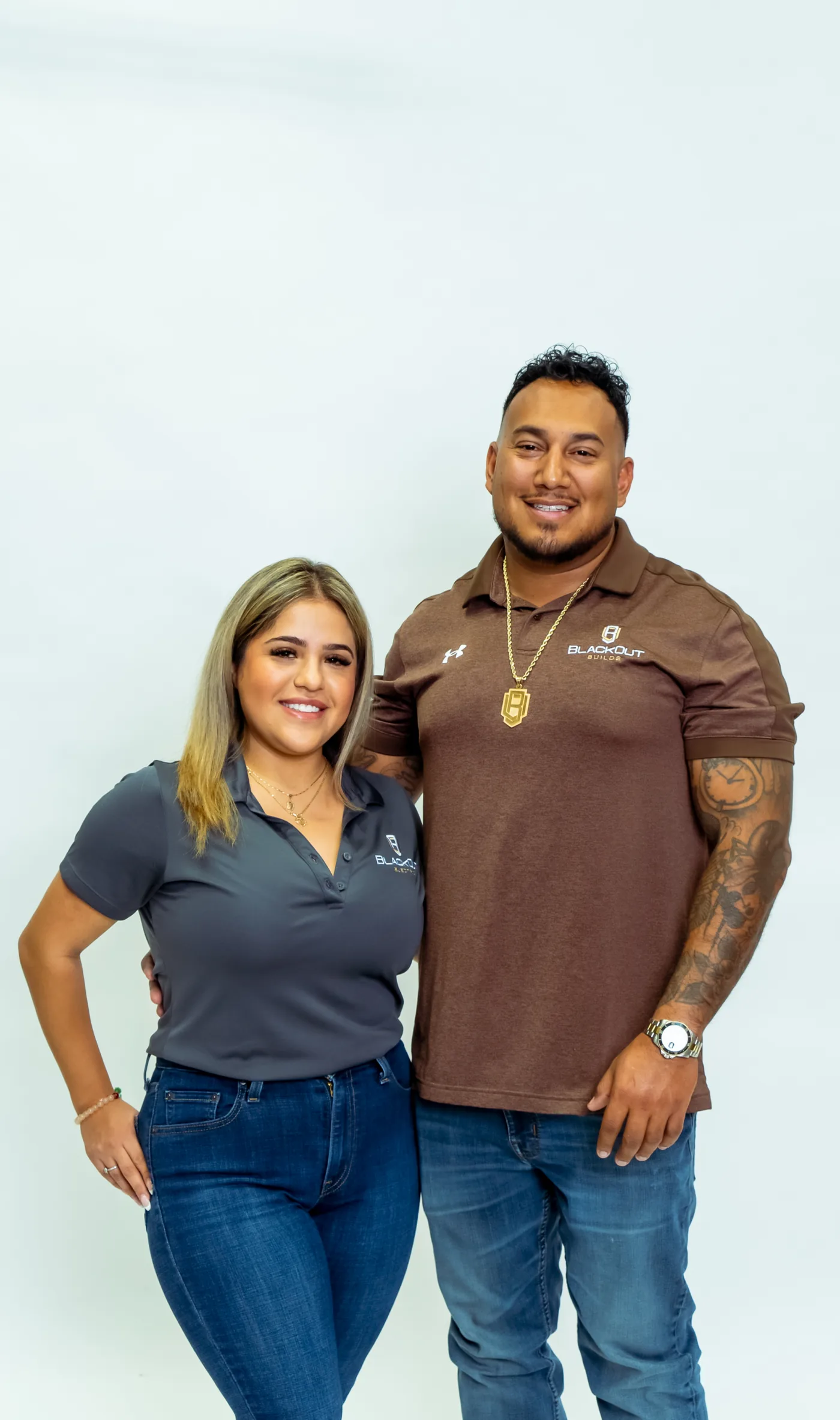 Two Blackout team members in company polos, one Blackout Electric and one Blackout Builds