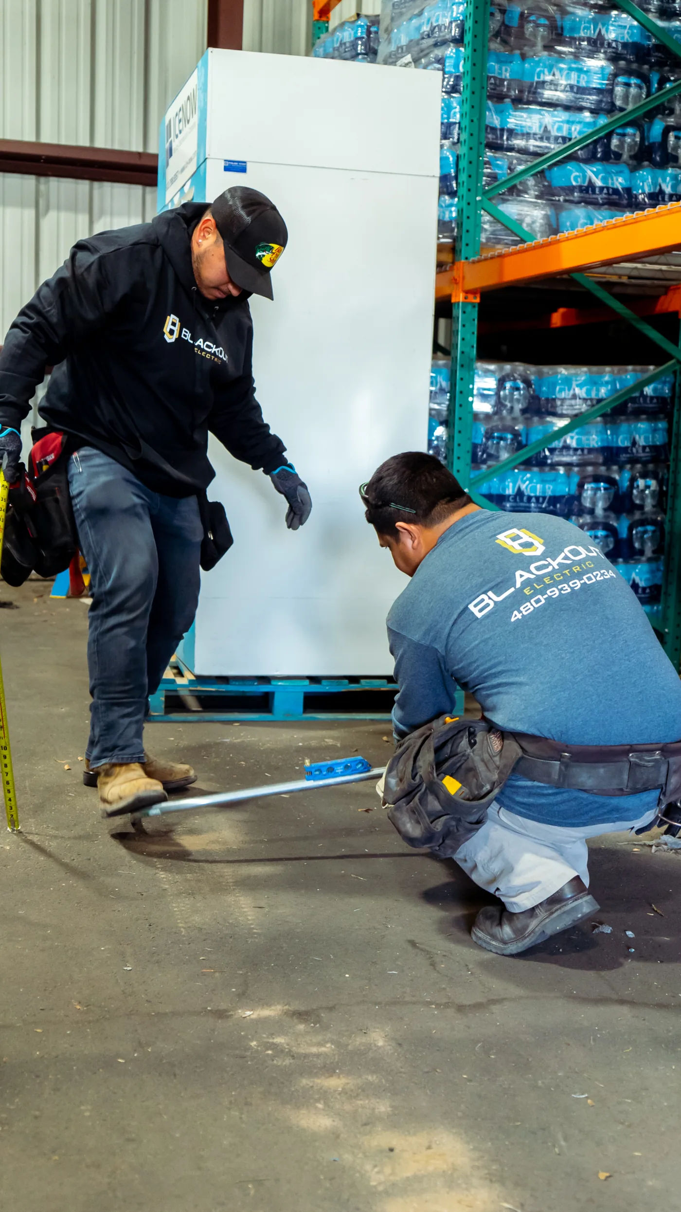 Blackout Electric crew measuring out a job in the shop